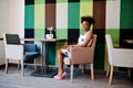 ÃÂ¡heerful african american young woman in summer dress at cafe.